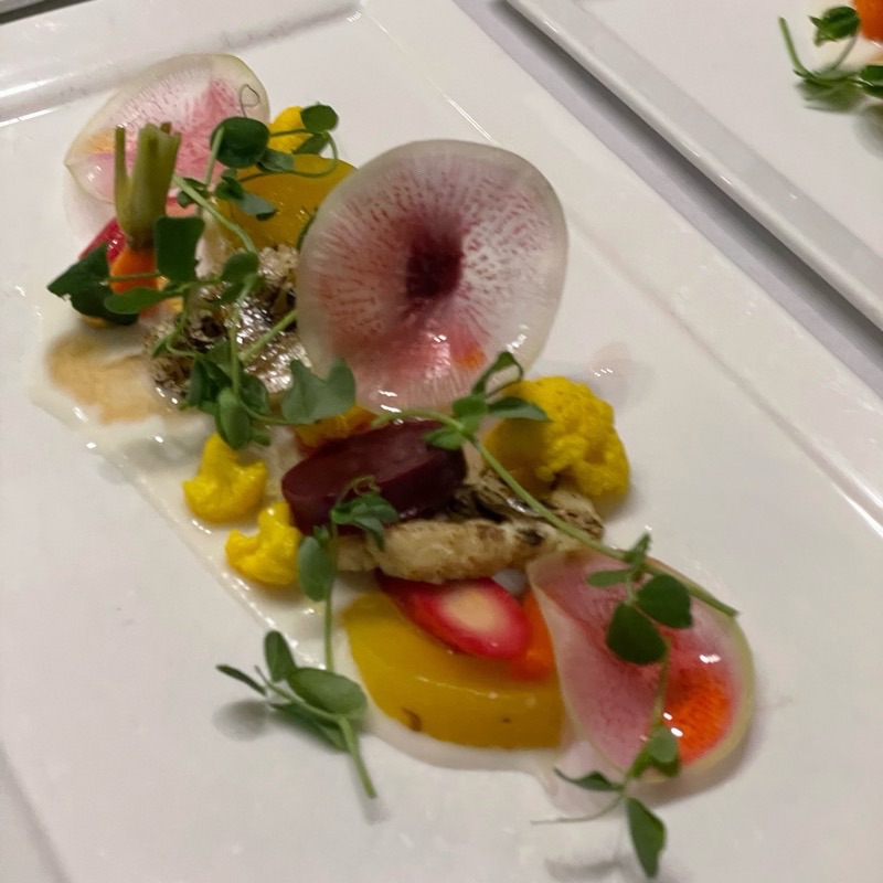 Plated beet salad with red and golden beets, watermelon radish, yellow cauliflower and pea shoots